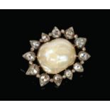 A 19th century mabe pearl and diamond brooch. The large pearl centre 15mm x 12mm is bordered by