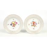 A pair of 19th century Vienna plates. Each pierced with lattice borders and decorated in coloured