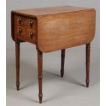 A Regency mahogany drop leaf sewing table raised on tapering ring turned supports and with two