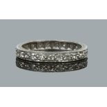 A white metal and diamond eternity ring. Milligrain channel set with round cut diamonds, size M.