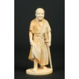 A Japanese carved ivory okimono. Formed as a Samurai apprentice holding his sword and raised on an