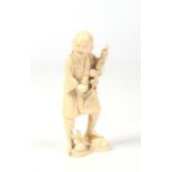 A Japanese Meiji period carved ivory small okimono. Formed as a man stood holding a branch with