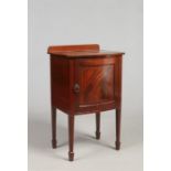 An Edwardian mahogany pot cupboard with strung inlay, raised on square tapering supports with