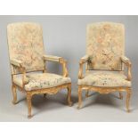 A pair of early 20th century carved giltwood open armchairs. With overstuffed tapestry upholstery