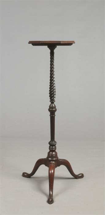 A Georgian mahogany torchere. With octagonal top raised on a twisted column on a plain cabriole