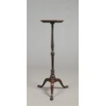 A Georgian mahogany torchere. With octagonal top raised on a twisted column on a plain cabriole