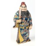 A Japanese Meiji period Satsuma figure of a warrior. Modelled holding a sword and wearing a long