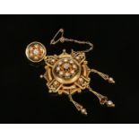 A large Victorian 18 carat gold pendant with stripped black enamelling. The principal medallion is
