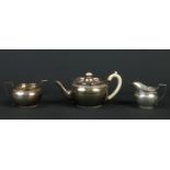 A George V silver three part tea set by C. S. Harris & Sons Ltd. With open fretwork galleries,