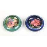 Two small Moorcroft bowls. One ground in cobalt blue decorated with the Fuscia pattern and the other