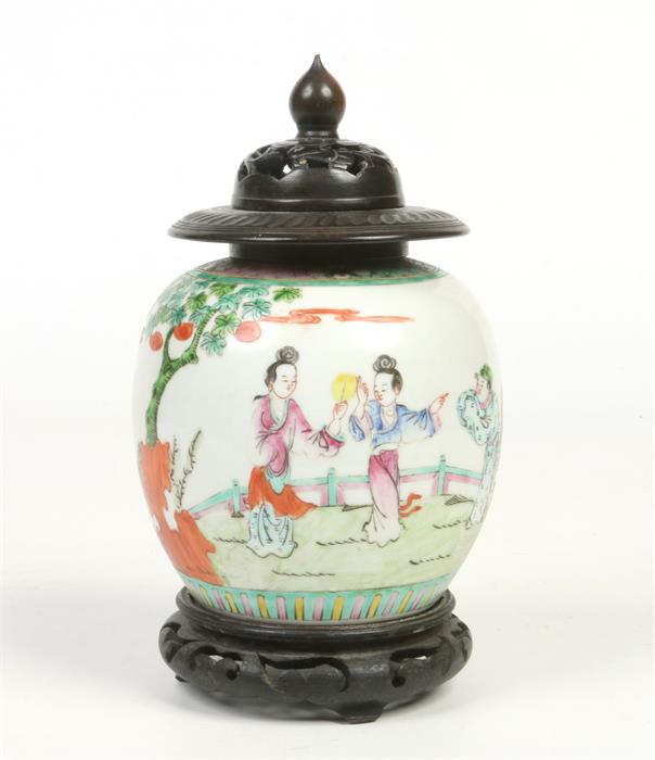 An early 20th century Chinese famille vert ginger jar with associated hardwood cover and plinth.