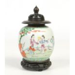 An early 20th century Chinese famille vert ginger jar with associated hardwood cover and plinth.