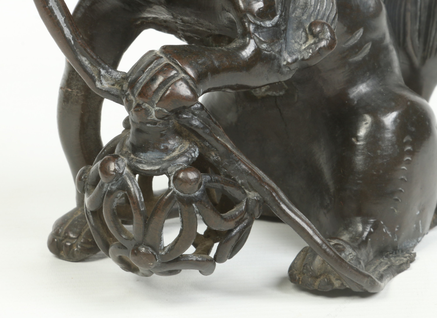 An antique Chinese patinated bronze sculpture of a lion dog guarding a brocade bowl, possibly - Image 2 of 7