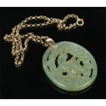 A Chinese jade pendant of oval form. Pierced and carved to depict a parrot. Supported on a 9 carat