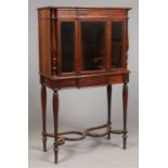 A Regency rosewood breakfont bookcase of slender proportions. With a single drawer to the frieze,