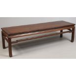 A Chinese late Qing dynasty hardwood low table. With pierced frieze stepped cross stretchers and