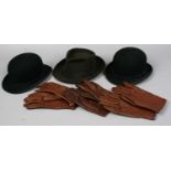 Two bowler hats a J.P Dunn & Co Fedora and three pairs of brown leather gloves.