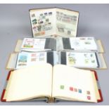 Two albums of mainly British first day covers, along with two albums of world stamps.