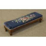 A rectangular footstool with turned legs and woolwork tapestry top.