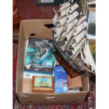 A collection of nautical themed items to include model ship 'Cutty Sark' ship in a bottle, books,