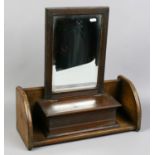 An Edwardian carved mahogany bevel edged mirror / glove box, along with a mahogany book stand.