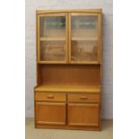 A 1970's teak G plan display unit over cupboard and drawer base.