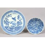 An 18th century Chinese blue and white charger painted with a bird of prey along with a smaller dish