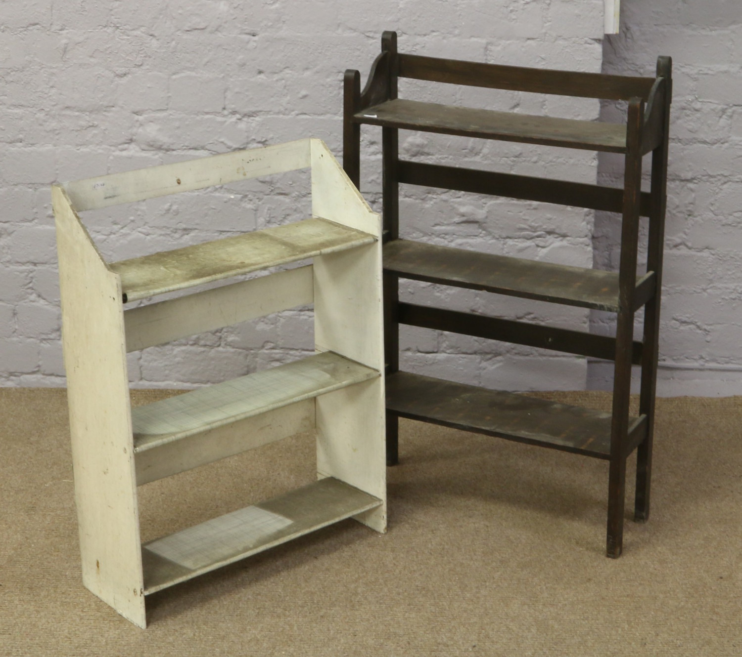 An oak open bookcase along with a painted example.