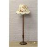 A mahogany standard lamp with reeded column and floral shade.