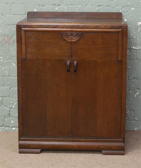 A 1940s carved oak tallboy.