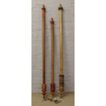 Three mahogany curtain poles including rings with turned and ball finials, along with four pairs