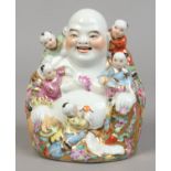 A 20th century Chinese famille rose figure group formed as a Buddha and five children, impressed