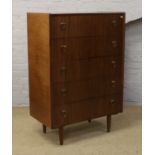 A retro style chest of five drawers on turned supports.