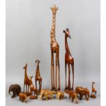 A collection of decorative carved wooden elephants and giraffes.