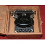 A vintage Empire No. 2 typewriter in pine case.