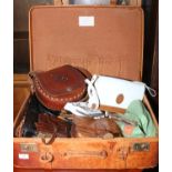 A leather suitcase containing a quantity of ladies handbags including leather satchels, beadwork,