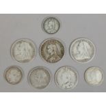 A collection of Victorian silver coins including half crowns, shillings and florins.