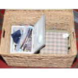 A rattan basket and three sewing boxes to include sewing equipment.