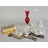 A collection of cut glassware's to include vase, shot glasses etc, along with three vintage tin