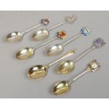 Seven silver and silver gilt spoons including six enamelled souvenir collectors spoons.