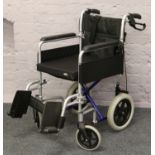 A Careco folding wheel chair with safety harness.