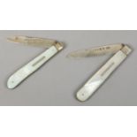Two silver folding fruit knives with mother of pearl scales.