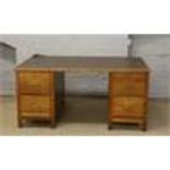 An oak twin pedestal desk.