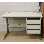 A cantilever desk with three drawers.