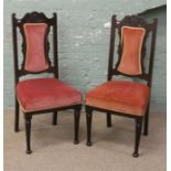 A pair of Edwardian carved mahogany upholstered salon chairs.