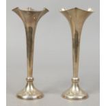 A pair of George V silver specimen vases of tapering form and with trefoil openings, assayed