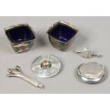 A group of silver items to include Scottish brooch, pair of salt cellars, compact etc.