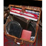 A basket containing assorted silver plated wares including cutlery, gallery tray and cased sets