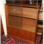 A teak glass front bookcase, by Gibbs Furniture.