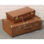 A wood bound travel trunk, along with a vintage suitcase with the original keys.